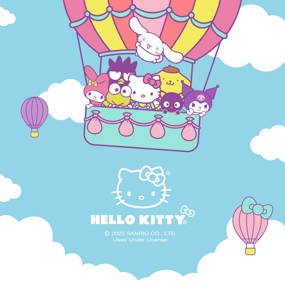 Carbella Hello Kitty next to laptop showing compact scale and portability
