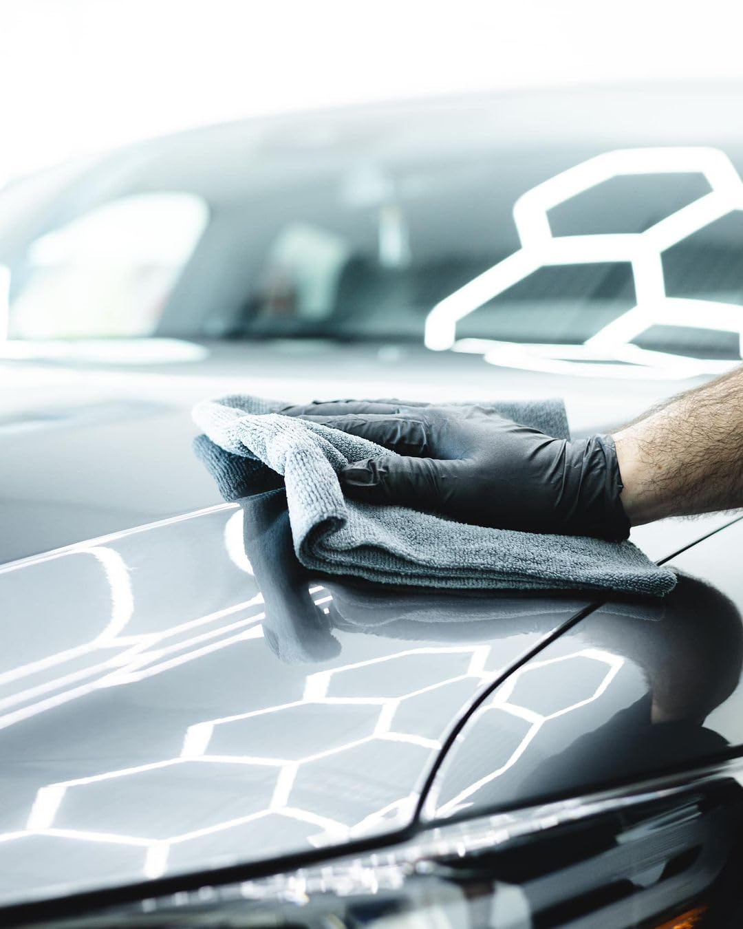 Person applying CARPRO DQUARTZ GO in a home garage illustrating DIY application convenience