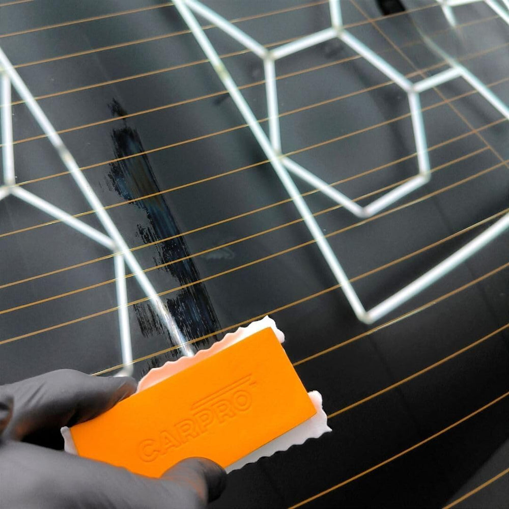CARPRO FlyBy30 being applied to a car windshield improving clarity