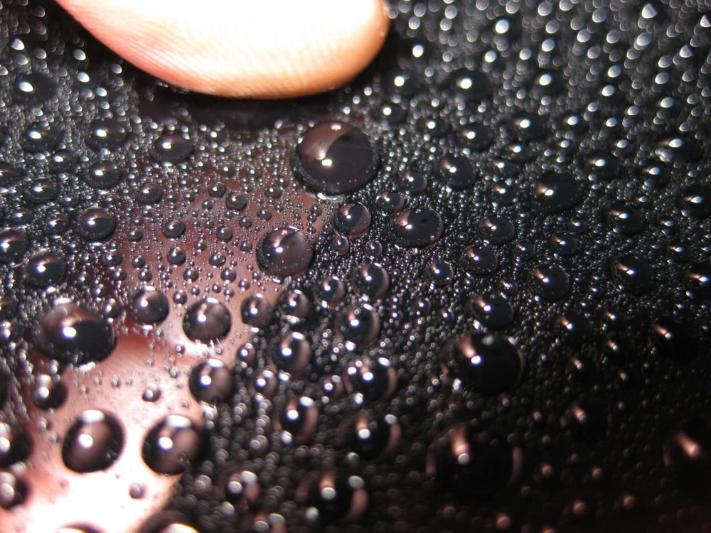 CARPRO spray application on car door demonstrating quick maintenance benefit