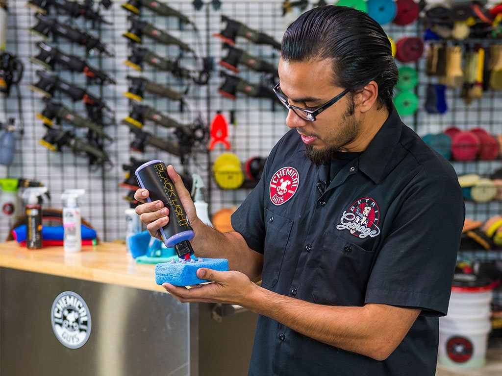 Chemical Guys bottle beside a detailing kit indicating professional use