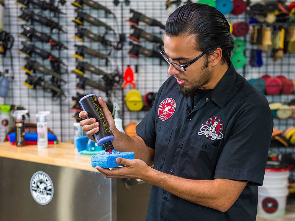 Chemical Guys bottle beside a detailing kit indicating professional use