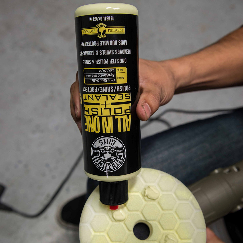 Chemical Guys 16 oz bottle next to hand for size reference and convenience