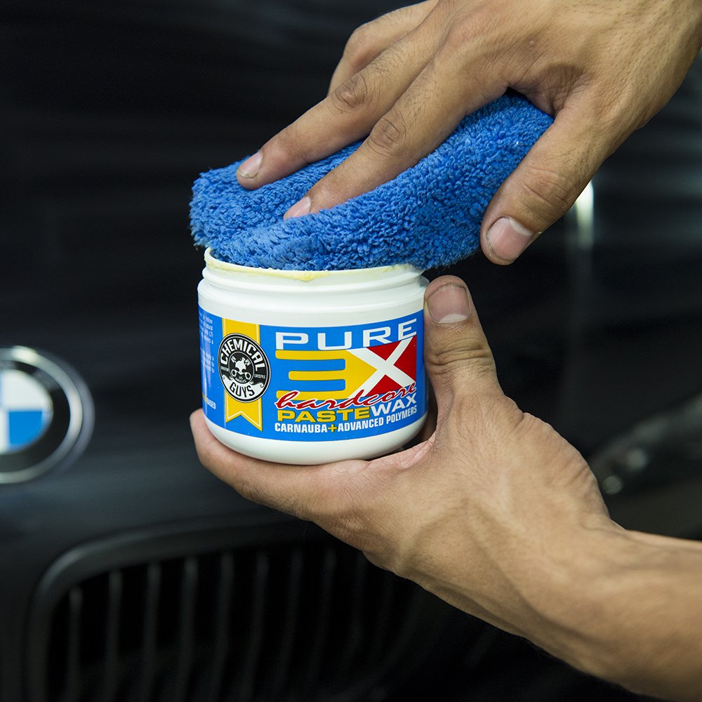 Chemical Guys 8 oz tin held in hand showing compact size and travel-friendly convenience