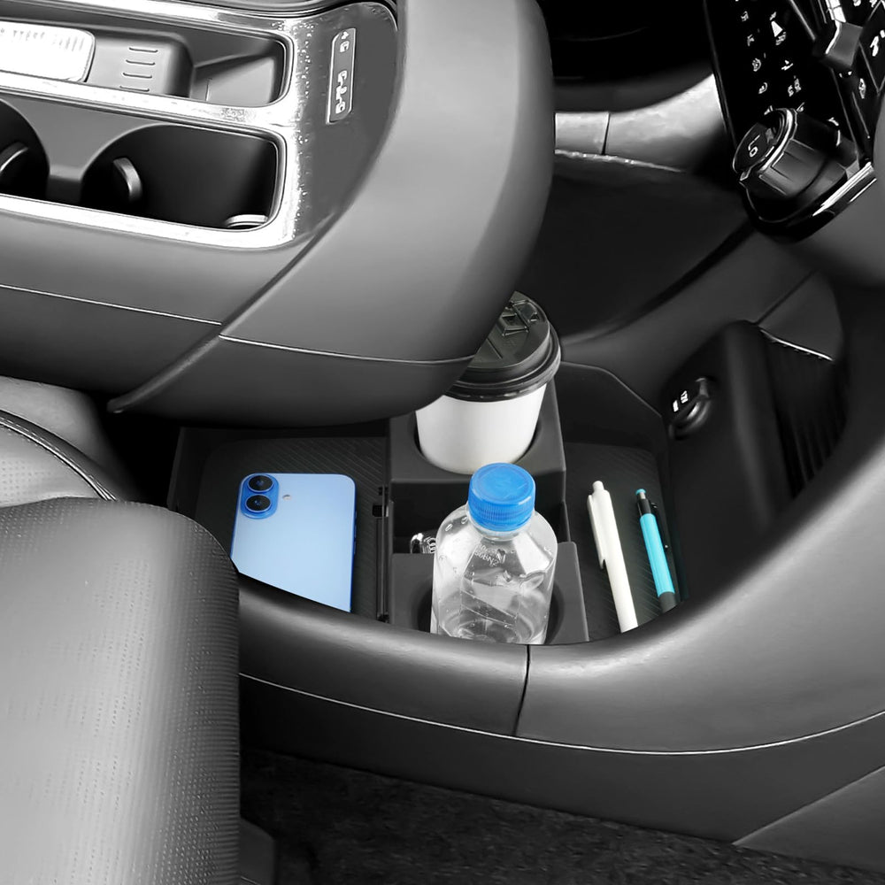 Coleya armrest and lower tray holding keys, glasses, and charger securely