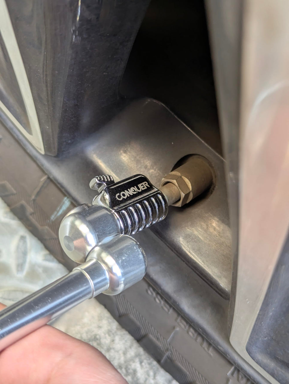 CONQUER in-use on RV tire showing ergonomic inflation and quicker service