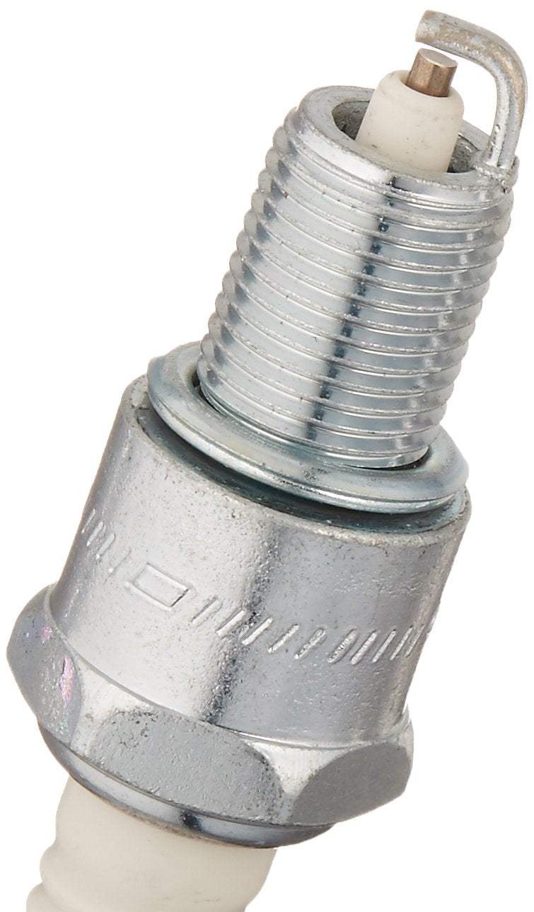 Cummins Onan spark plug close-up installed in generator highlighting reliable fitment
