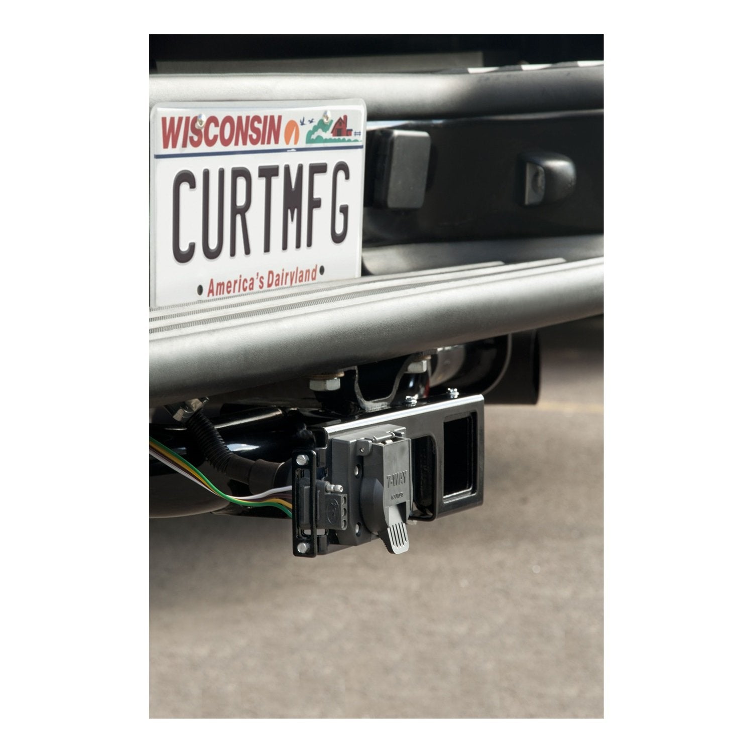 CURT installed on truck rear lifestyle shot showing protected trailer wiring