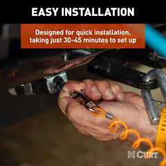 CURT breakaway cable and trigger close-up showing secure engagement benefit