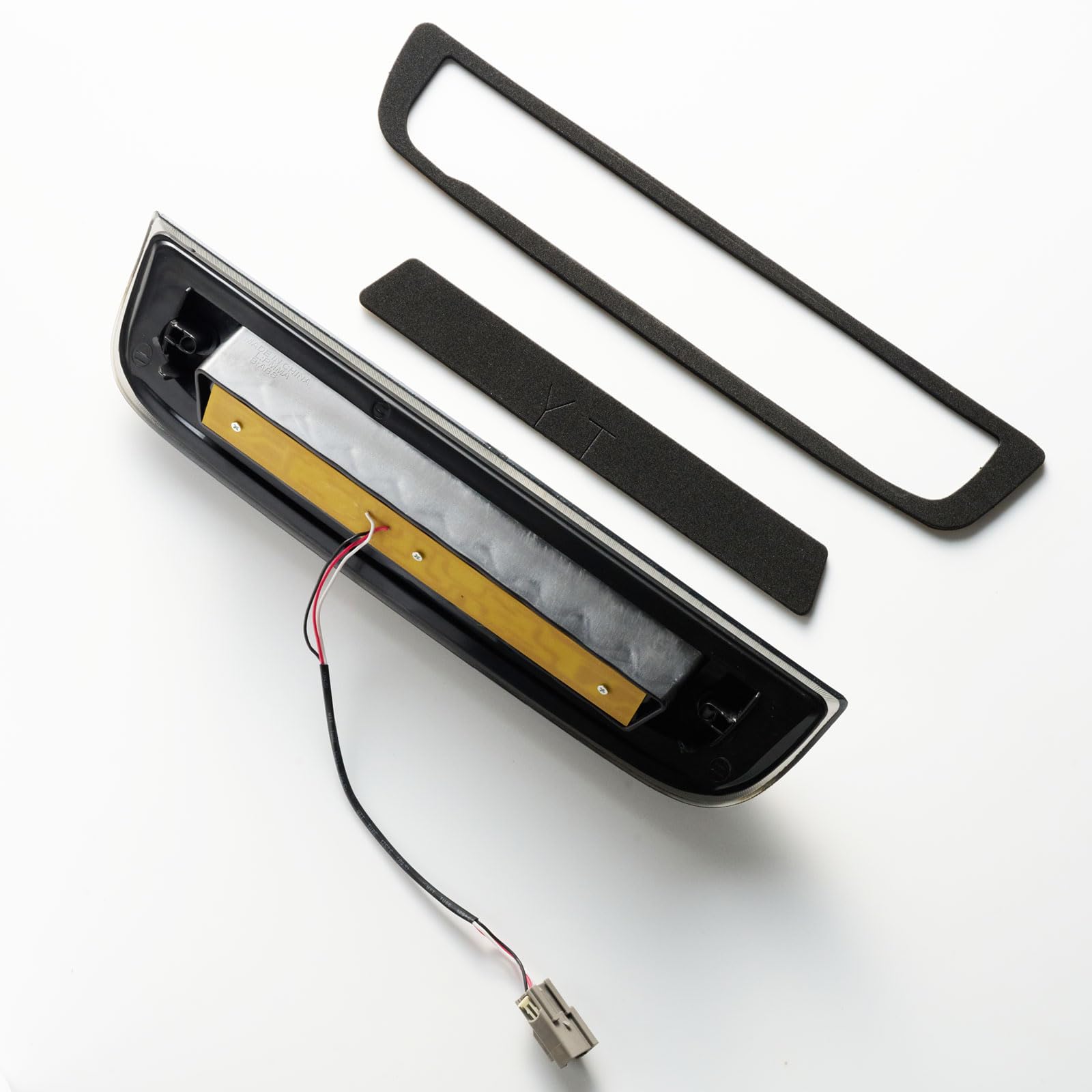 Cxdar brake light beside ruler showing compact size and correct fit