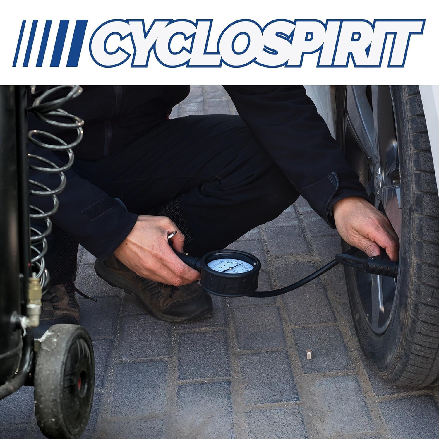 CycloSpirit inflator on a workbench next to a bicycle tire showing workshop-ready reliability