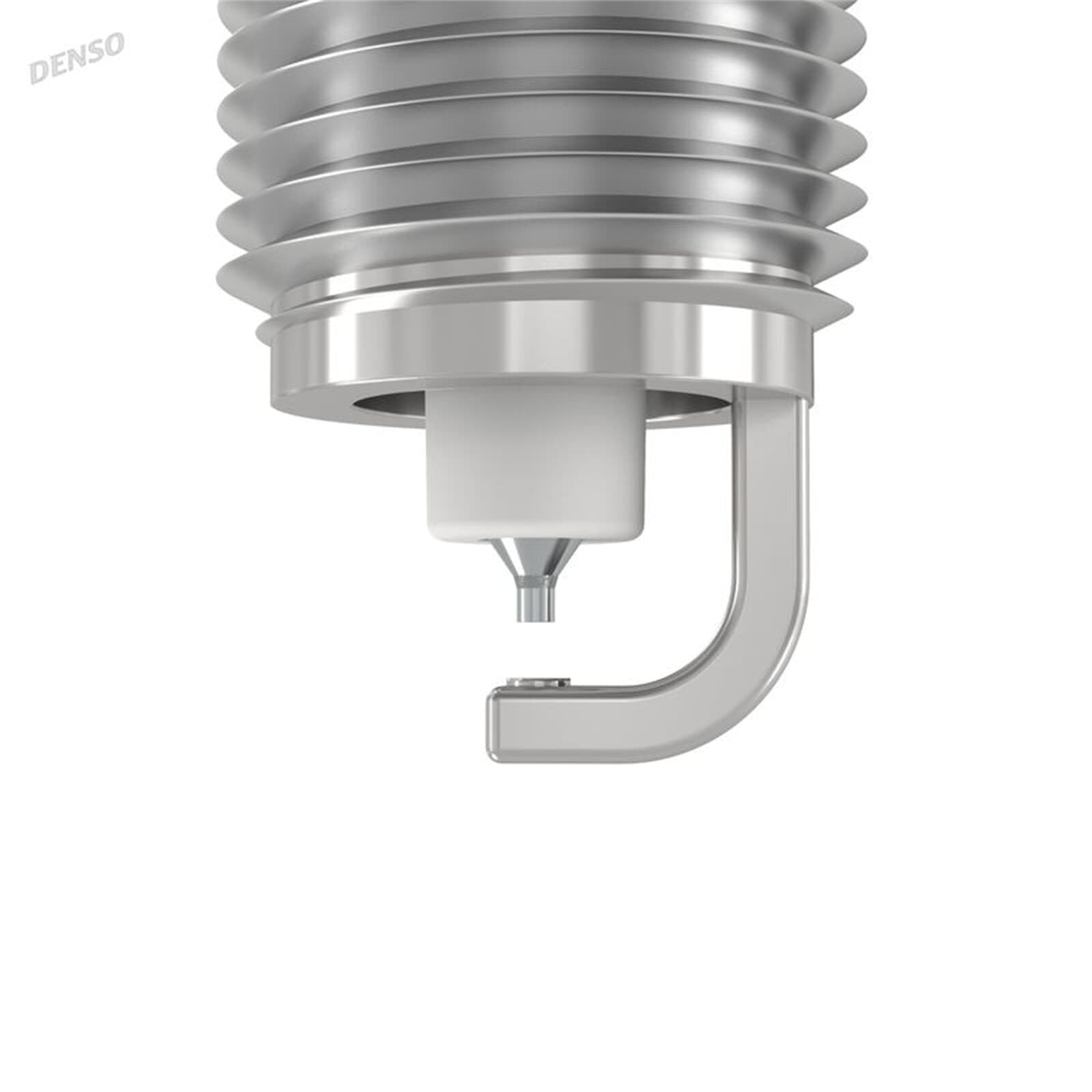 Denso plug beside a coin for scale showing size and precise 0.7mm electrode benefit