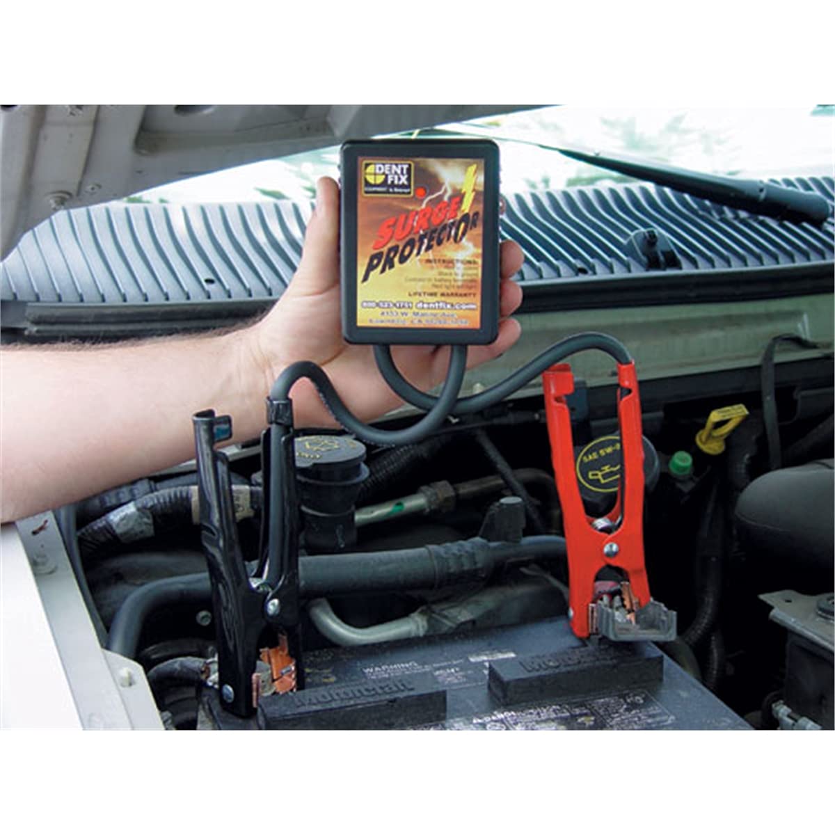 Dent Fix DF-601 LED and clamps connected to battery, showing active protection during use