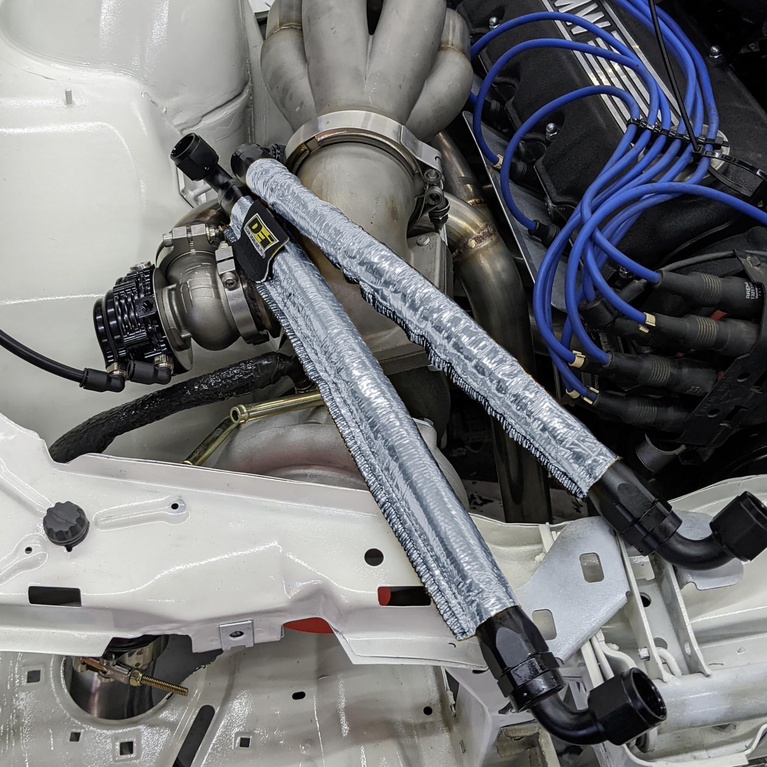 Design Engineering installed in engine bay protecting hoses from heat and debris