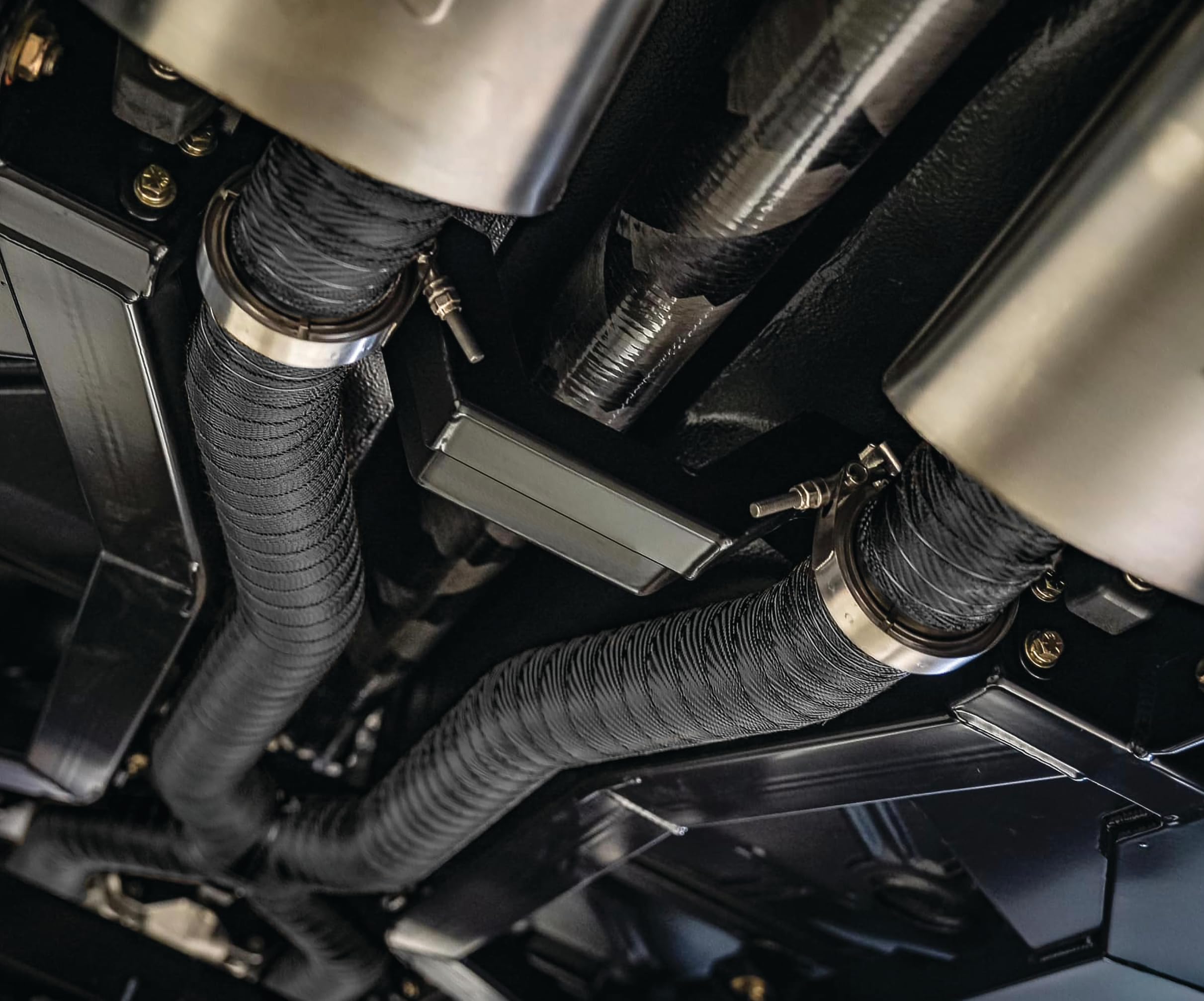 Design Engineering wrapped motorcycle exhaust displayed in lifestyle setting protecting parts
