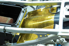 Design Engineering Reflect-A-Gold adhesive back exposed demonstrating strong bonding benefit