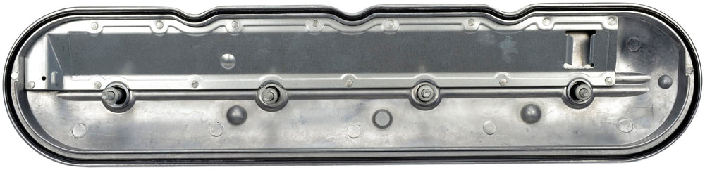 Dorman valve cover beside ruler for size comparison and fit confirmation