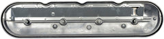 Dorman valve cover beside ruler for size comparison and fit confirmation