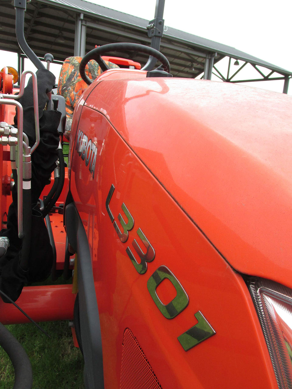 Durafit seat cover next to ruler showing tailored fit for Kubota models