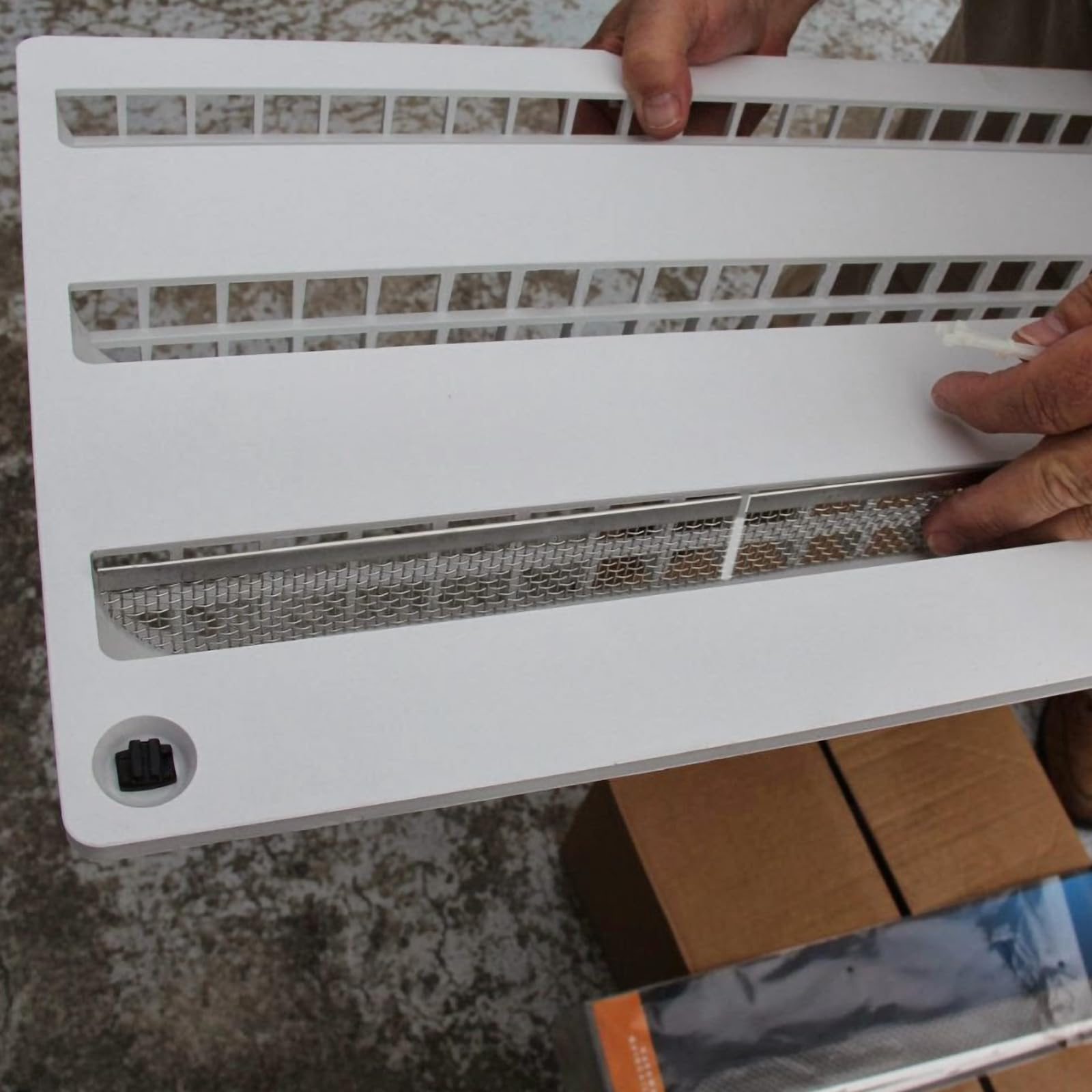 Eazy2hD rubber strip and spring fastener close-up protecting RV finish while securing the screen.