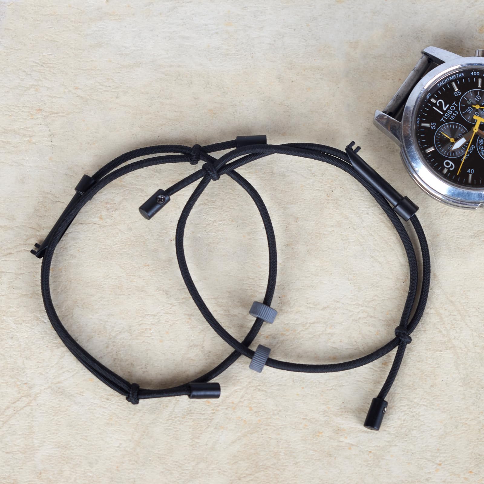 ECBANLI bracelet beside coin for scale showing compact portable sizing benefit