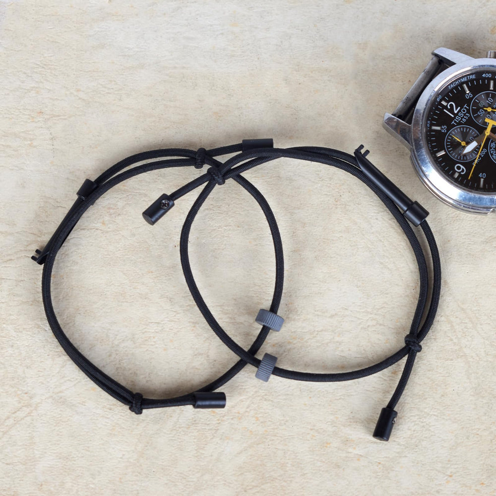 ECBANLI bracelet beside coin for scale showing compact portable sizing benefit