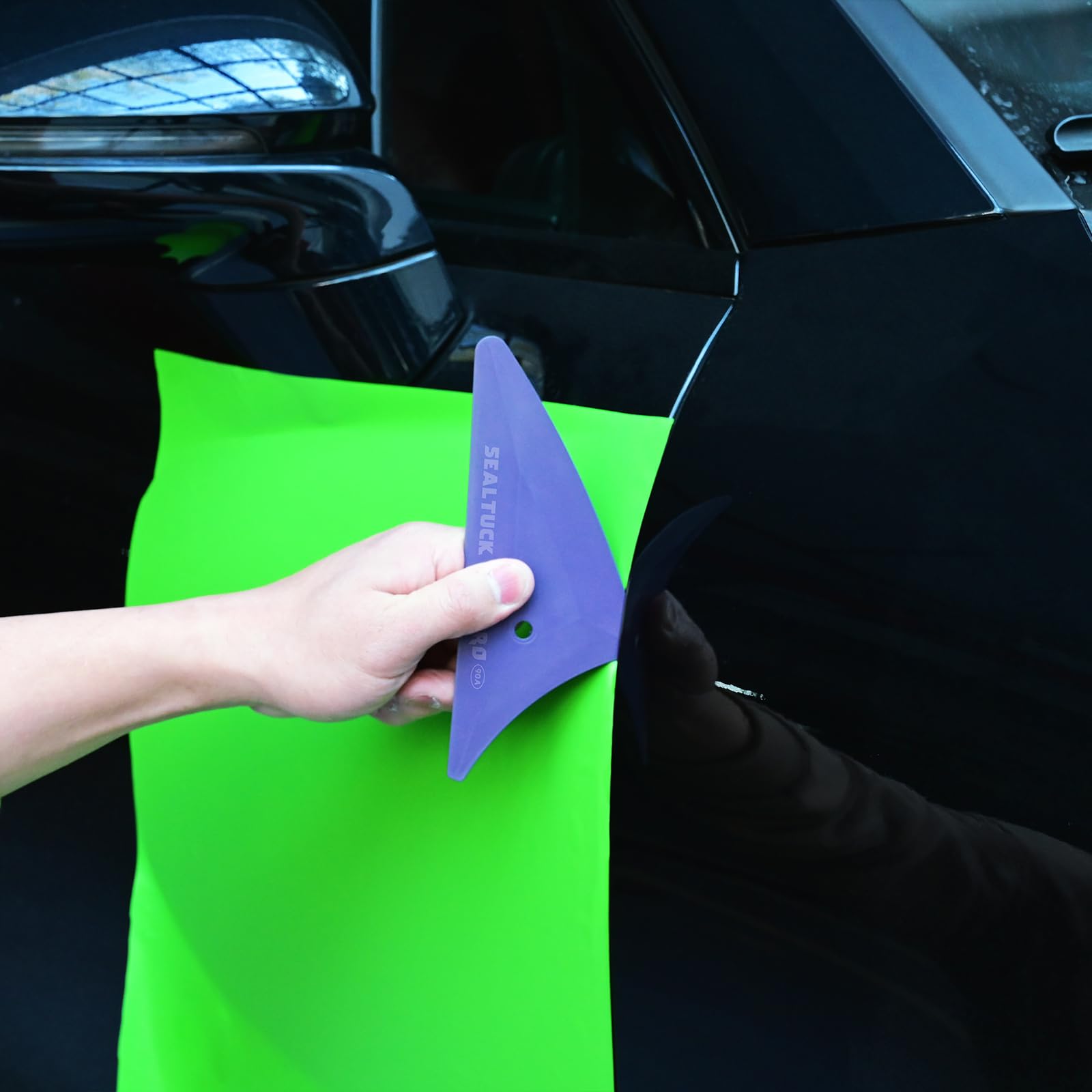 EHDIS using squeegee on car window showing clean professional finish