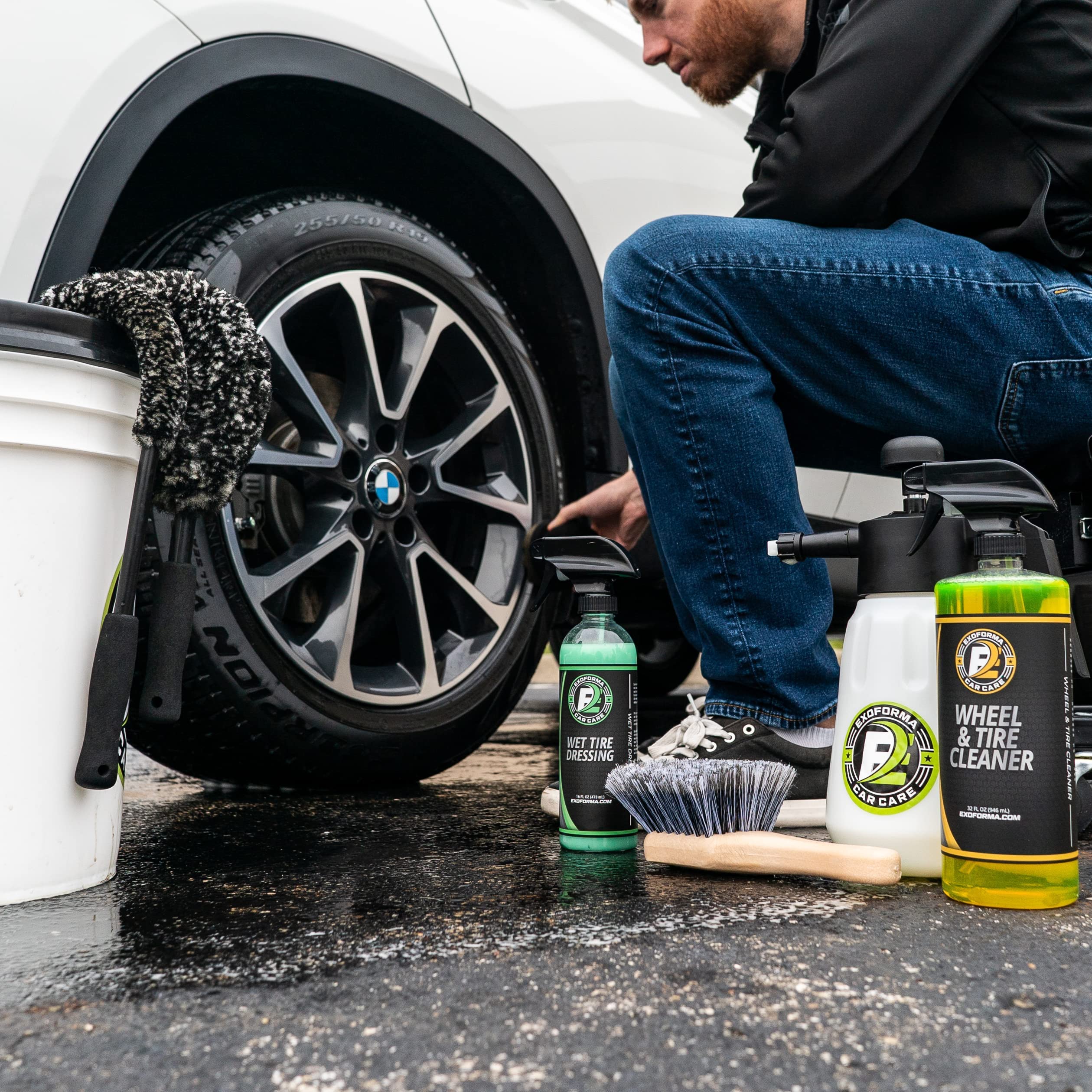 ExoForma lifestyle shot of a detailer using brushes on a sports car wheel