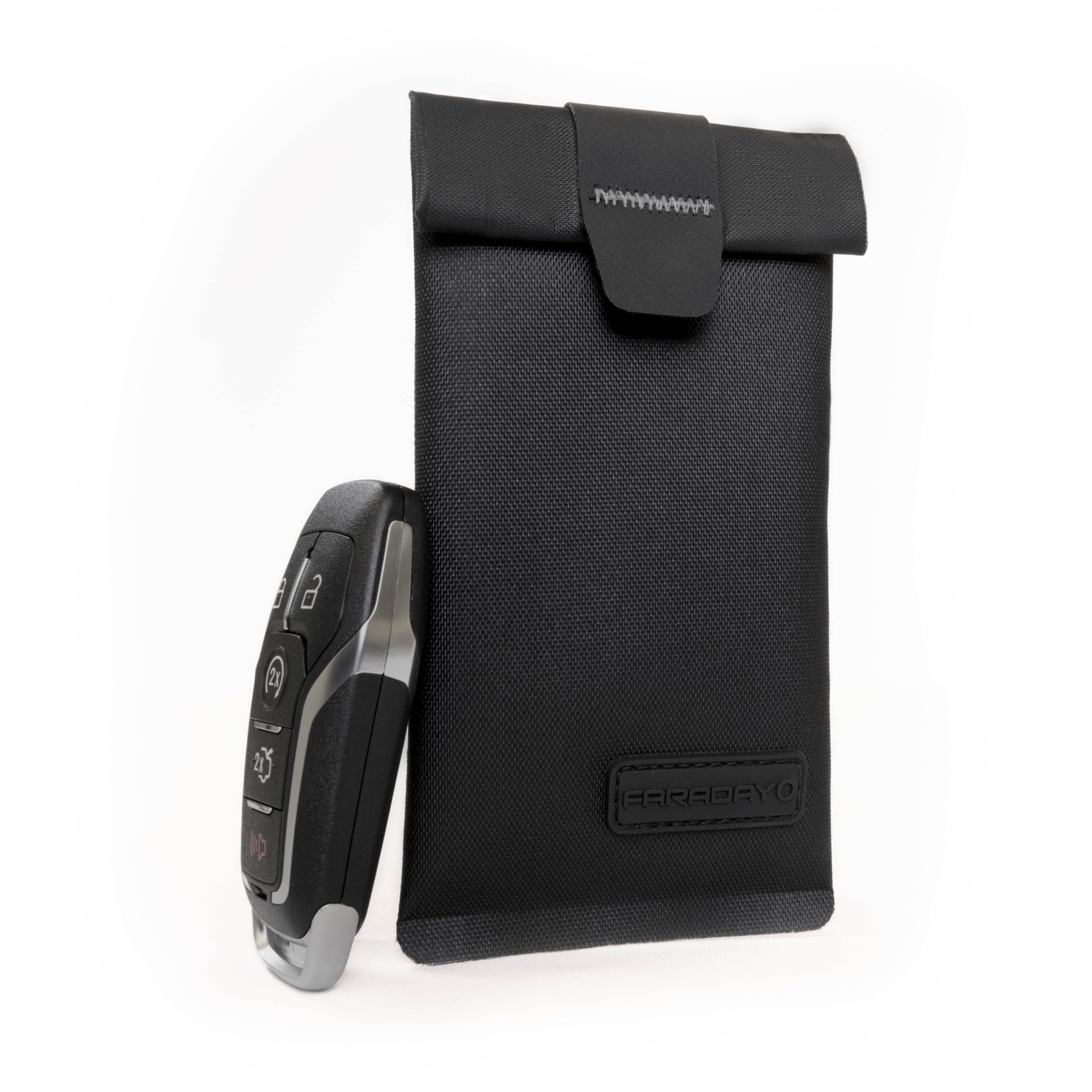 Faraday Defense with keys, credit card, and USB inside demonstrating multi-device shielding use