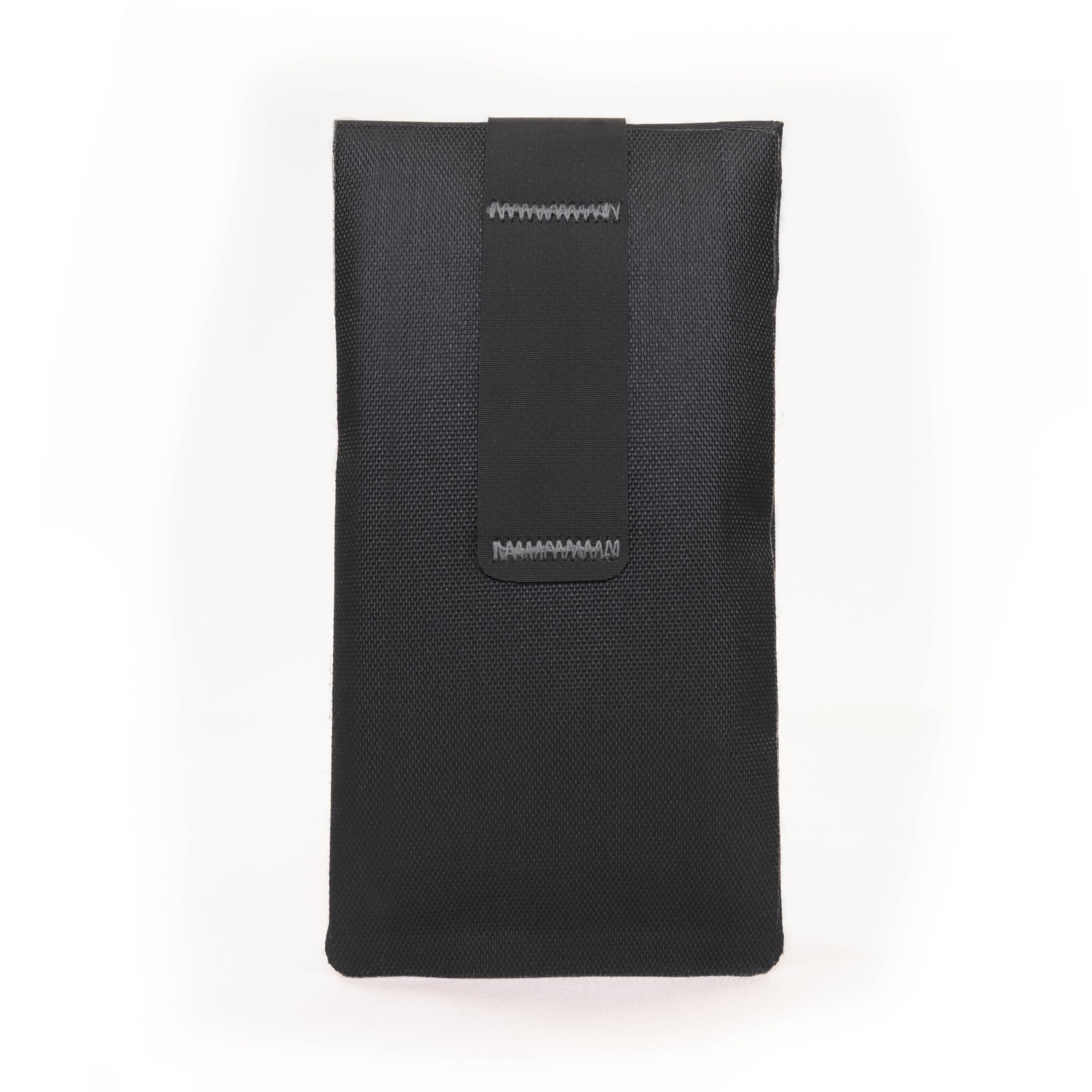 Faraday Defense jacket placed in car console highlighting theft-prevention use while parked