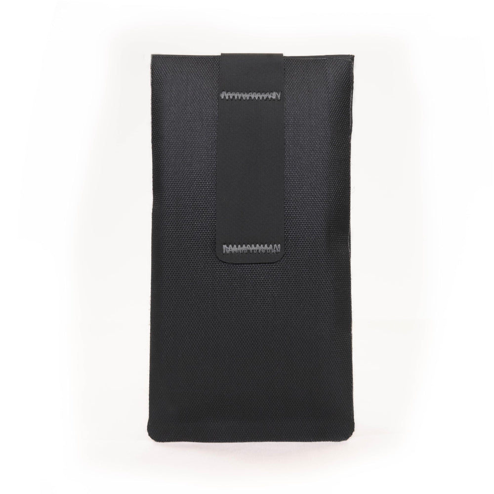 Faraday Defense jacket placed in car console highlighting theft-prevention use while parked