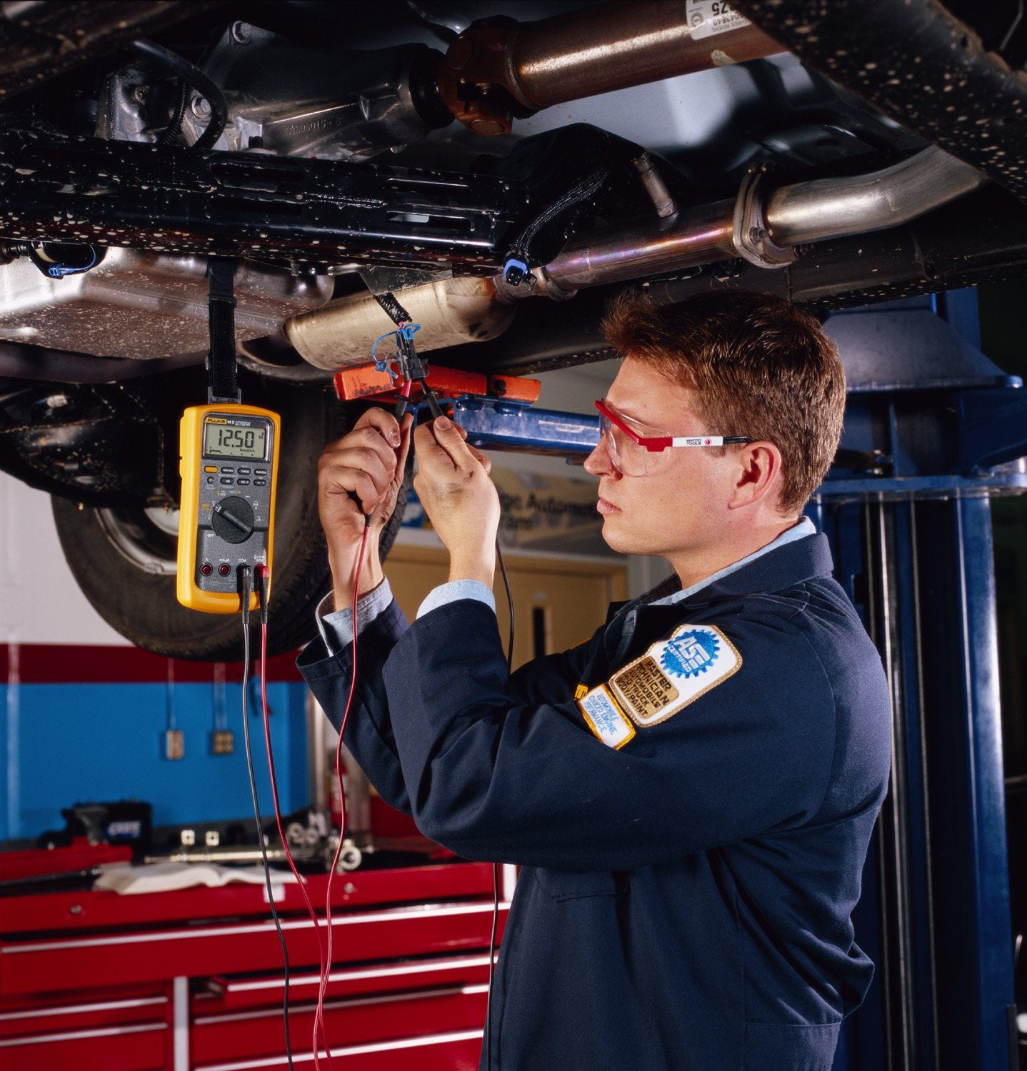 Fluke 88V in use under hood diagnosing a hybrid vehicle, speeds troubleshooting