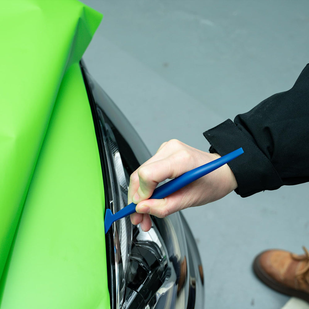 FOSHIO flexible handle squeegee being used to tuck tint into gasket