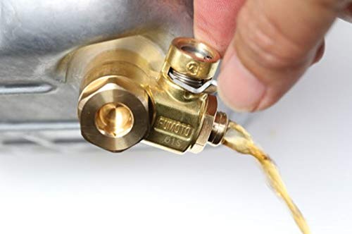 Fumoto F-107SX draining oil into pan showing spill-free capture benefit