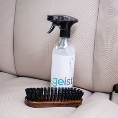 Geist being used on a car seat to remove grime and restore appearance