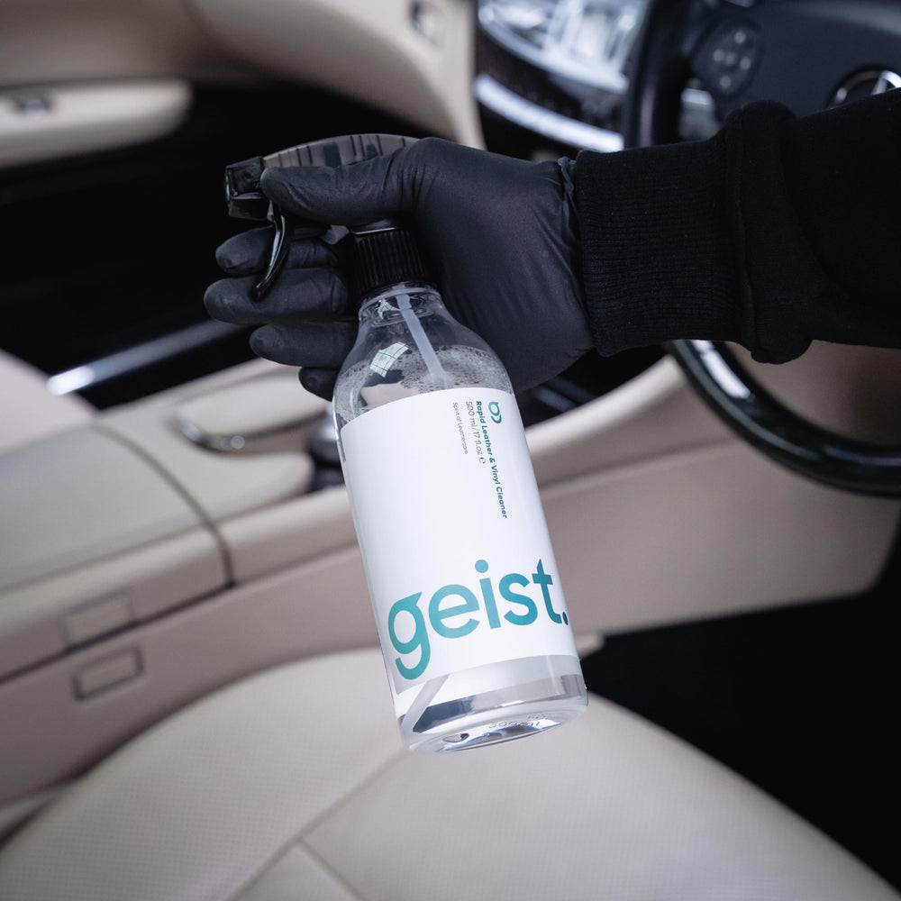 Geist bottle held in hand to show 500 ml scale and portability
