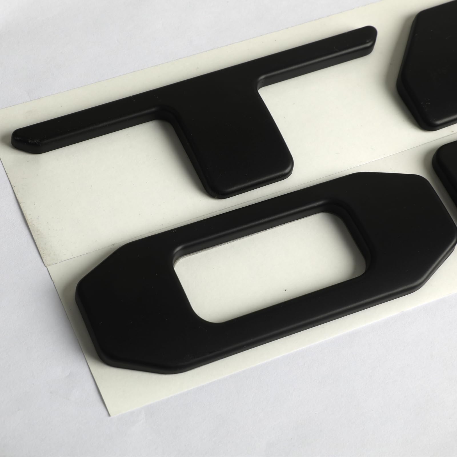 Generic brand tailgate letters in garage lifestyle scene enhancing style