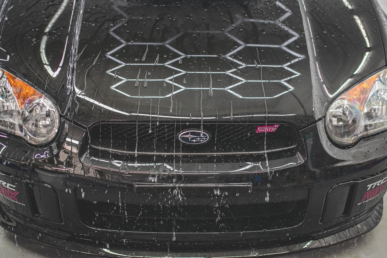 Gtechniq EXO water beading demonstration on a treated surface showcasing repellency