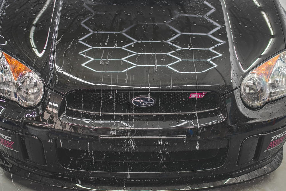Gtechniq EXO water beading demonstration on a treated surface showcasing repellency