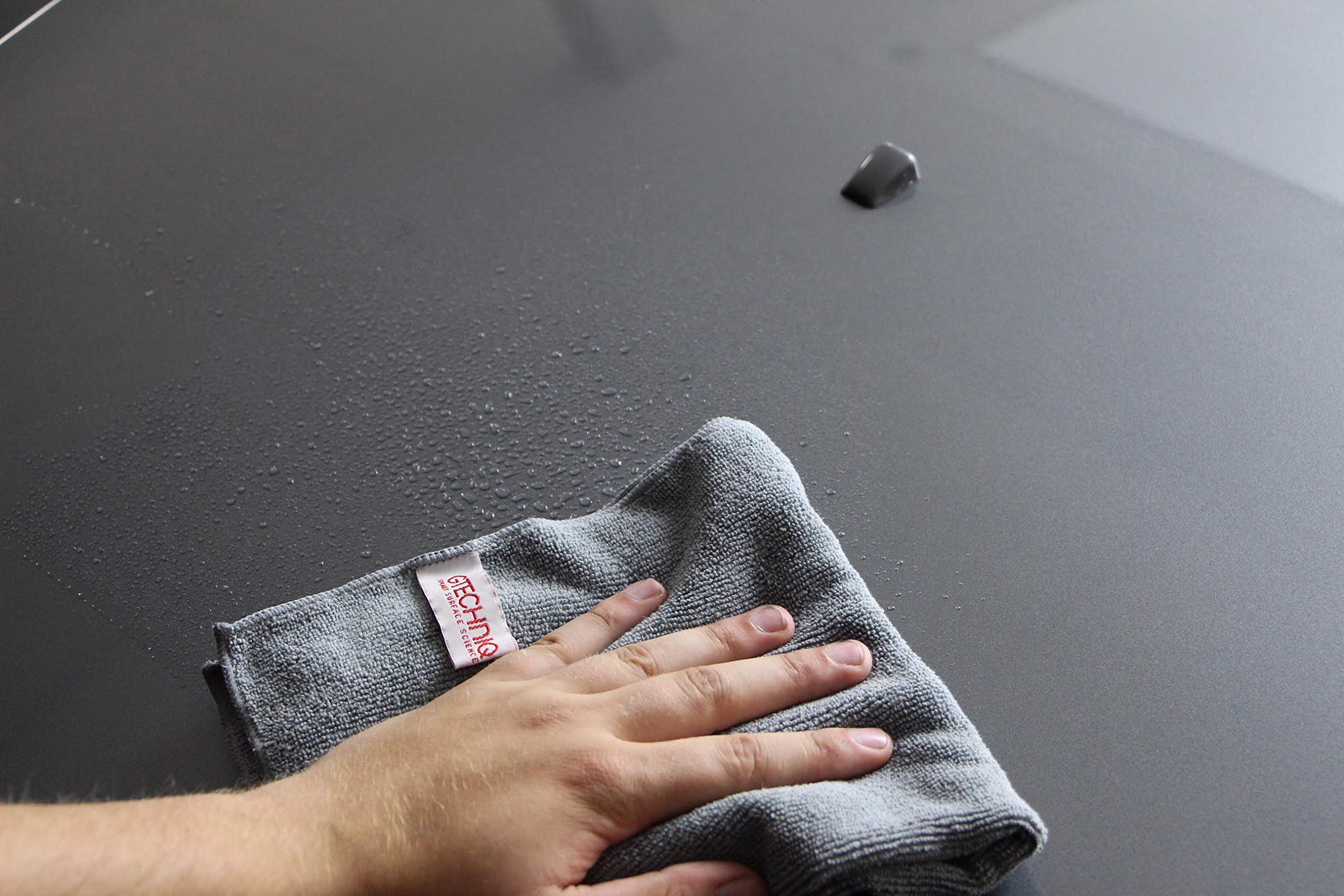 Gtechniq MF1 wiping car hood demonstrating safe finish cleaning without scratches