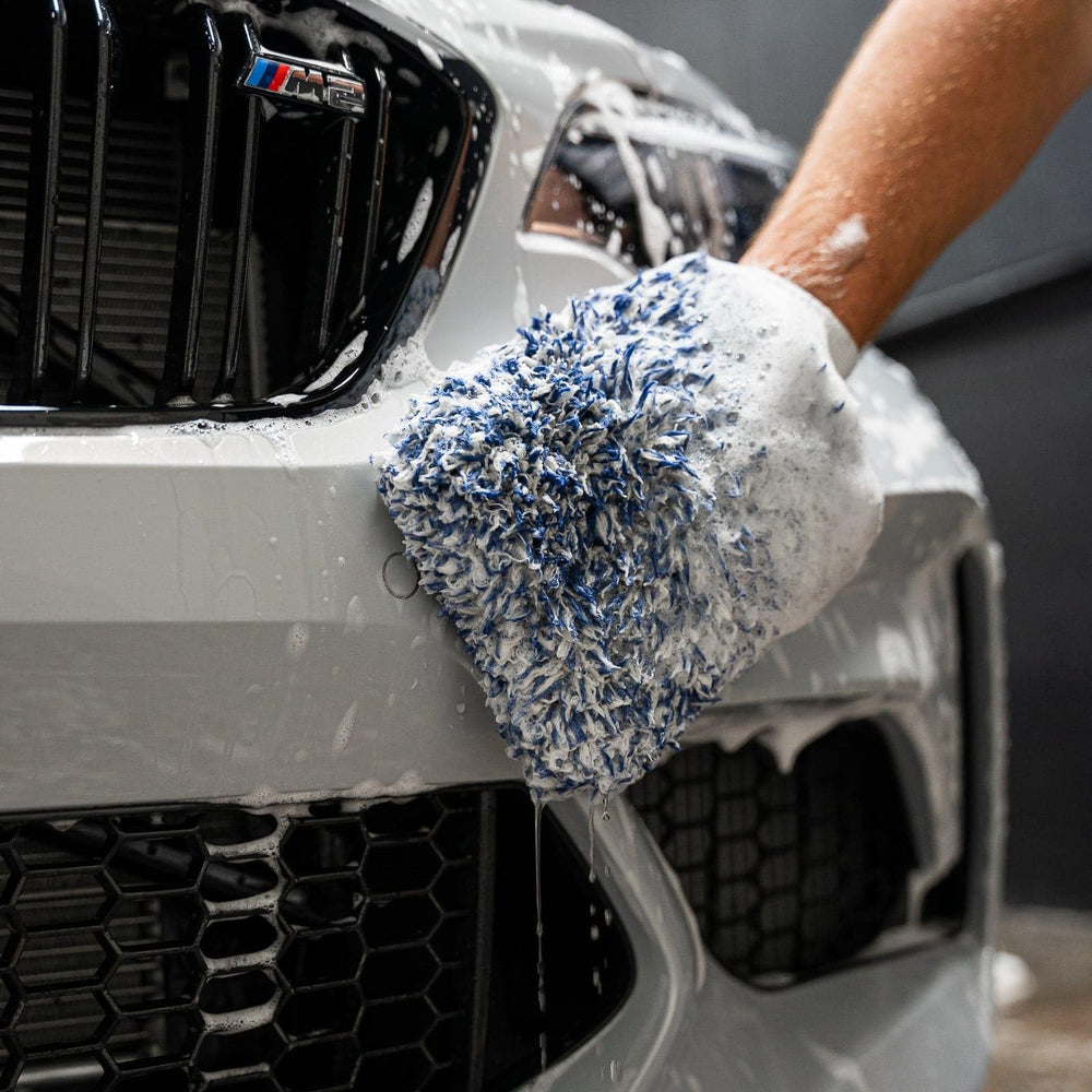 Gyeon mitt wet with soap lather demonstrating lubricated cleaning