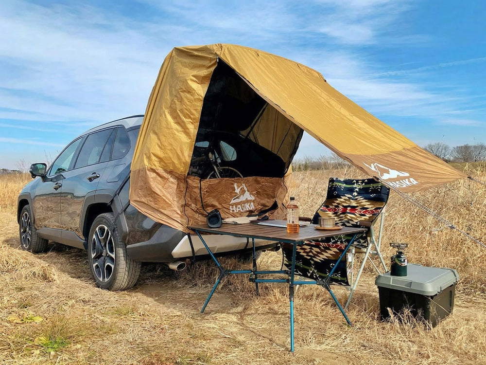 HASIKA tent next to person illustrating size and usable shade area for two people