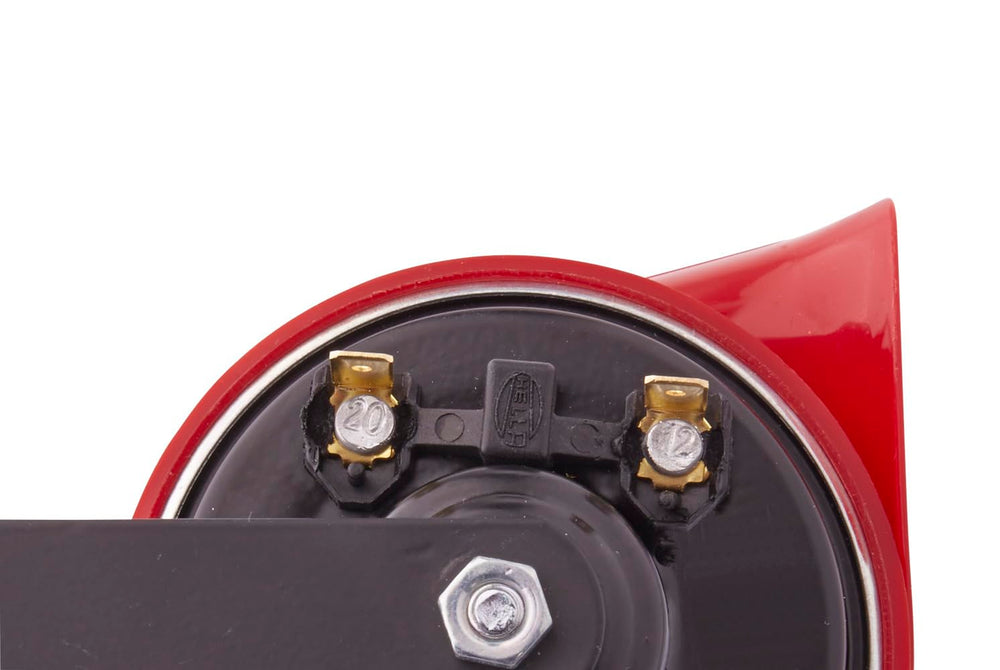 HELLA horn mounted on vehicle fender demonstrating secure installation