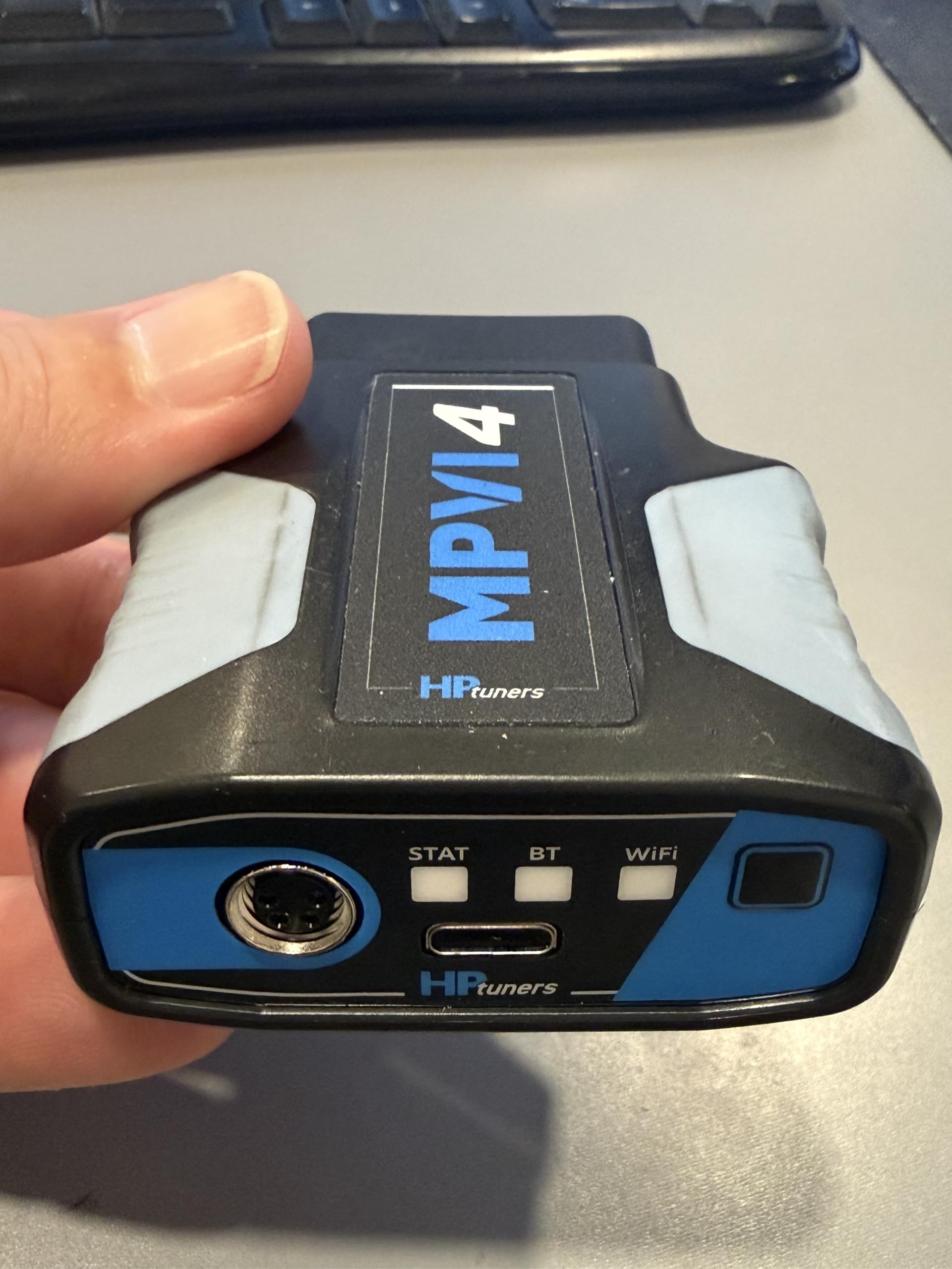 Hinson MPVI4 beside smartphone showing compact size and portability benefit