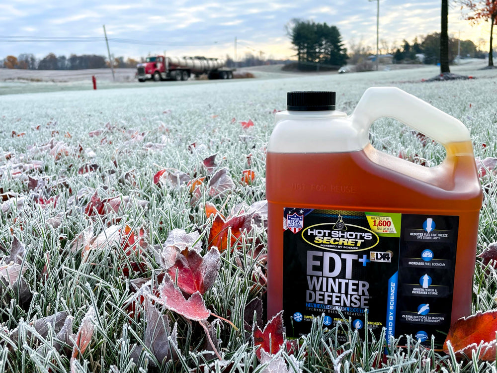 Hot Shot's Secret gallon on a workshop shelf indicating ready winter preparation