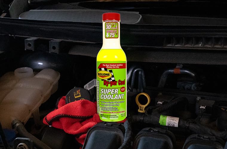 Hy-Per Lube bottle on a garage workbench next to a car and tools, ideal for DIY maintenance