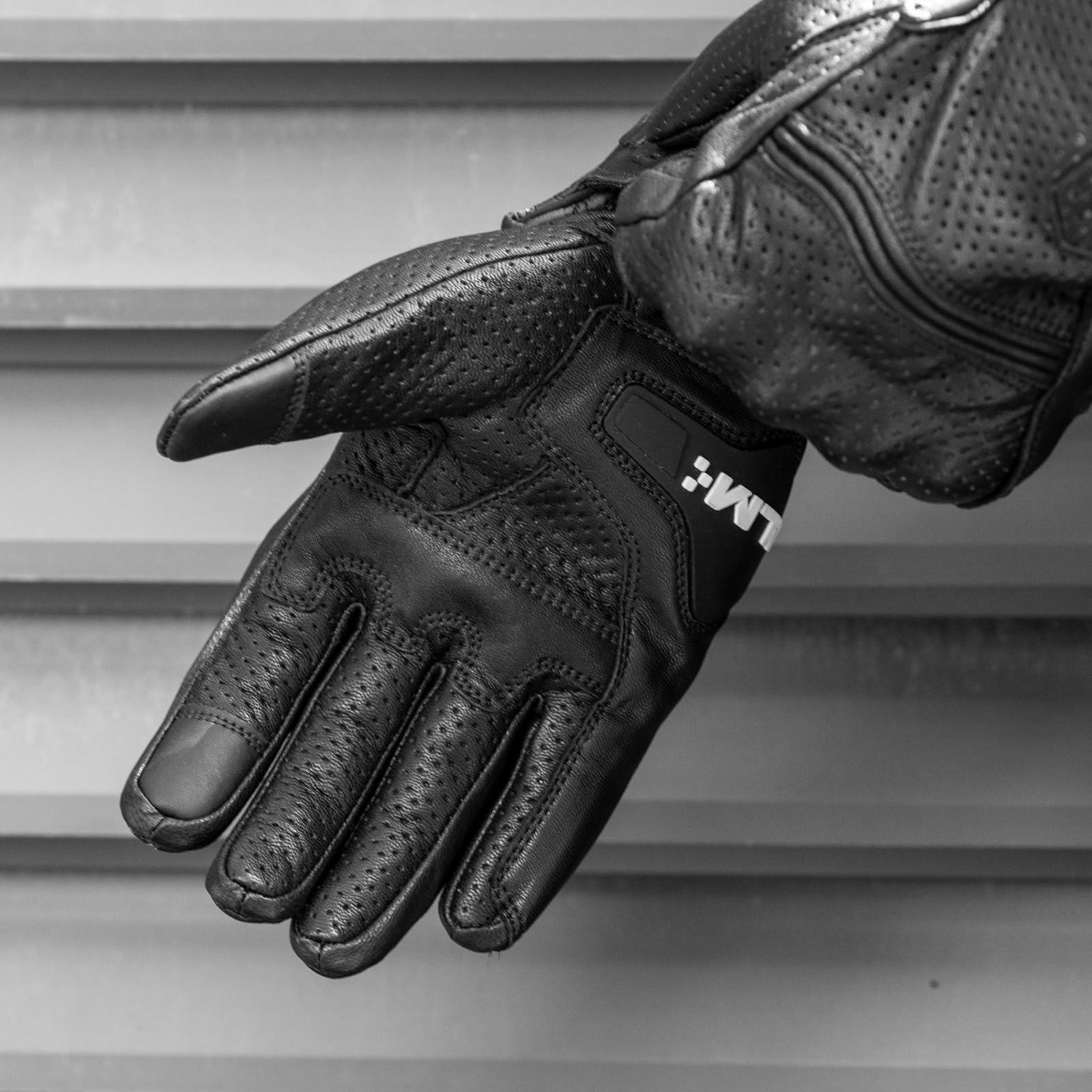 ILM DN01 worn on motorcycle levers showing control and tactile feedback