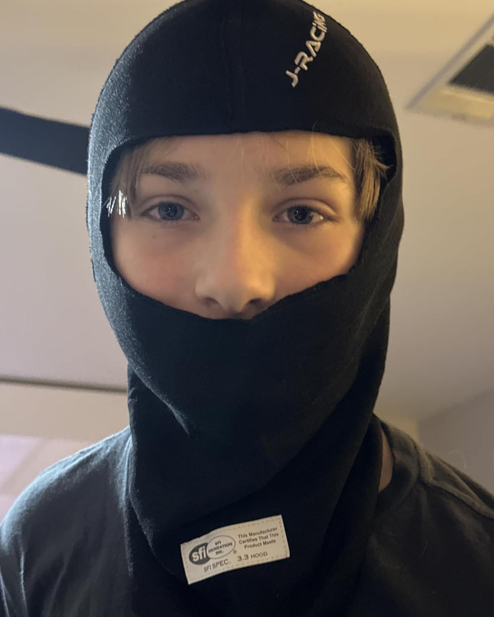 J-RACING balaclava on driver at track emphasizing comfort and performance