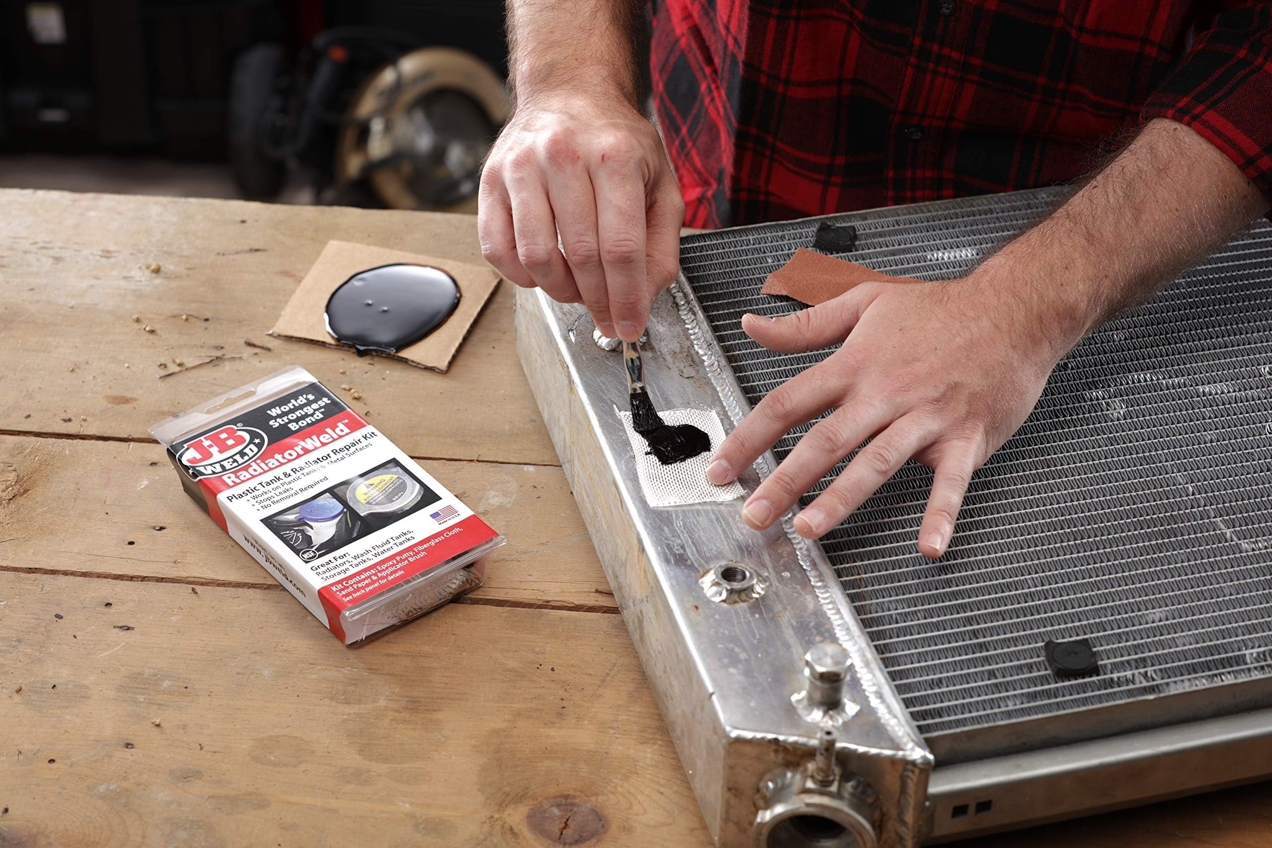 J-B Weld kit applied to a plastic radiator tank demonstrating on-vehicle repair benefit