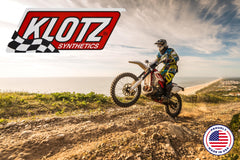 Klotz R-50 bottle beside an off-road motorcycle demonstrating compatibility